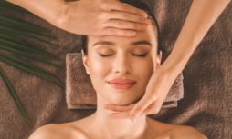 Beautiful young woman enjoying massage in spa salon, top view